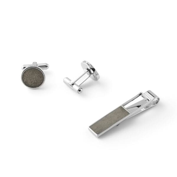 A steel + concrete set of cufflinks and tie pin.